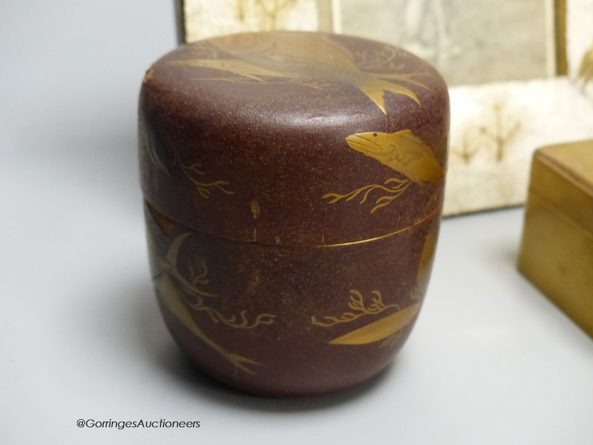 A Japanese lacquer jar and cover, a box and cover, a photo frame,22 x 18cm and an antimony figure of Gama Senin